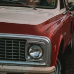 shallow focus photo of red single-cab truck